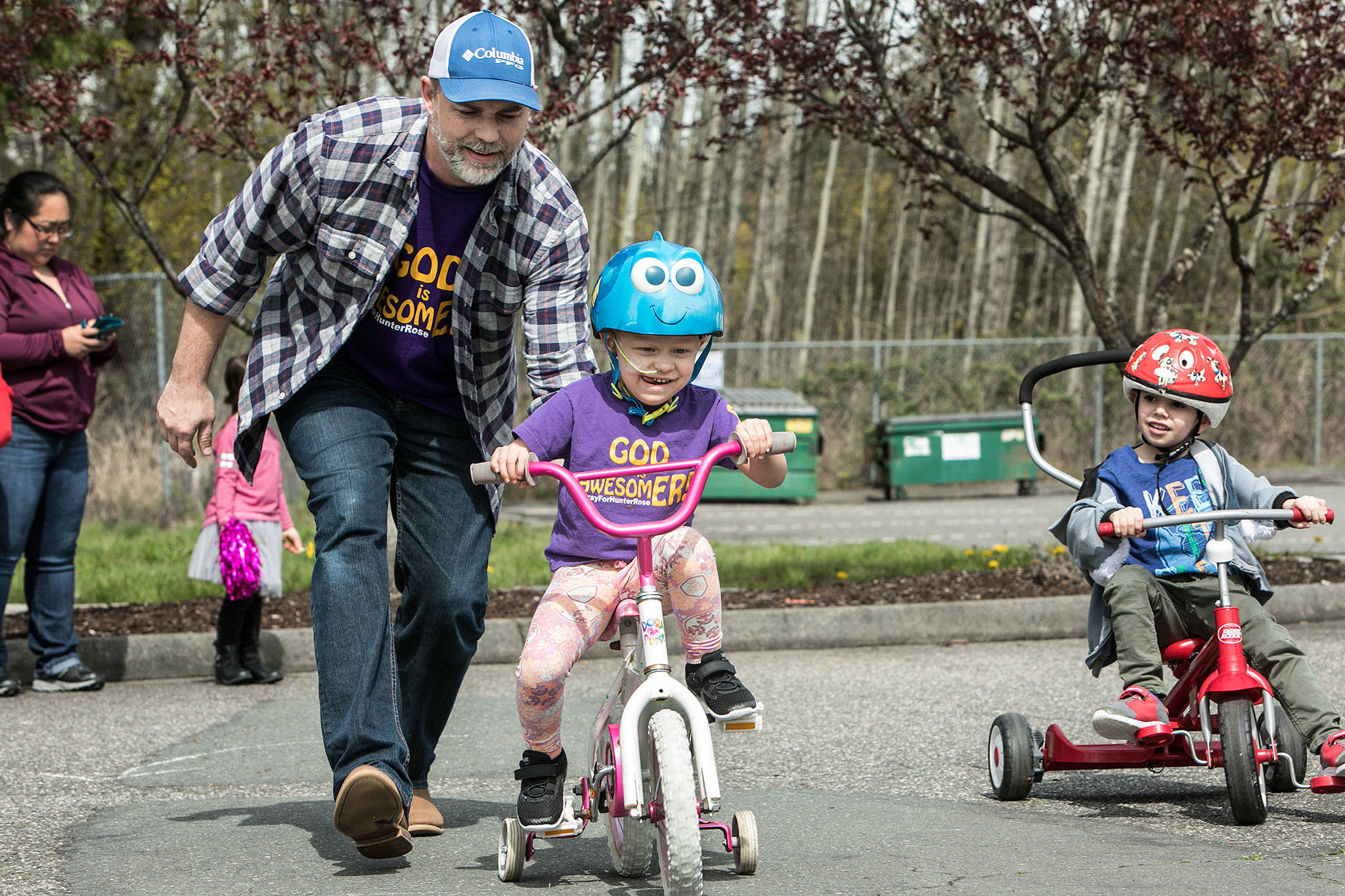 Hunter Rose Jones rides in the annual Prince of Peace Preschool trike-a-thon to raise money for Seattle Children’s Hospital on April 19 in Everett. Hunter Rose was diagnosed with stage four neuroblastoma in September. (Lizz Giordano / The Herald)