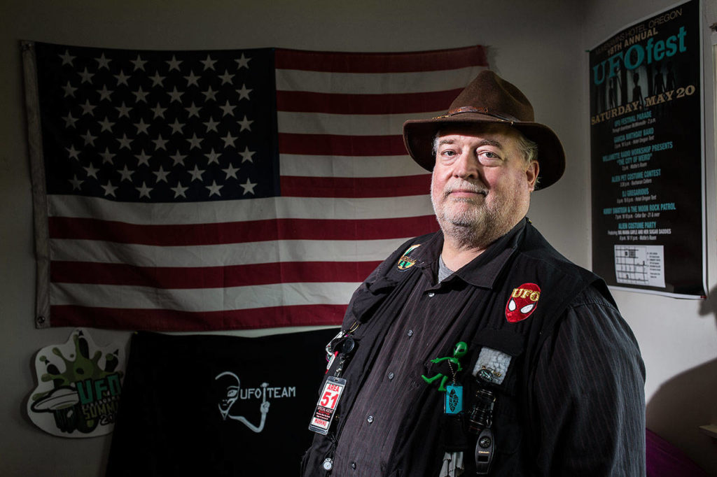 Michael W. Hall at home Wednesday in Edmonds. Hall heads a group, called the UFOiTeam, investigators who follow up on UFO sighting reports. The group meets weekly at the Denny’s in Lynnwood for live streaming discussions. (Andy Bronson / The Herald)

