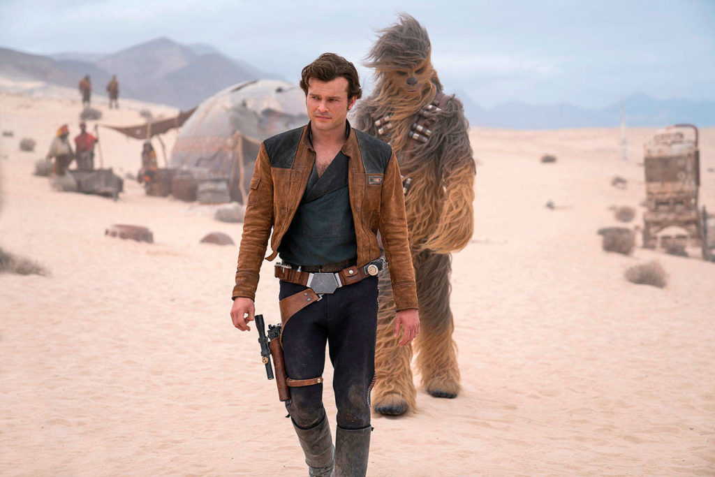 Alden Ehrenreich plays the young Solo in “Solo: A Star Wars Story,” in theaters May 25. With him as always is Chewbacca (Joonas Suotamo). (Lucasfilm)
