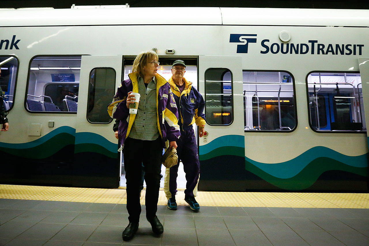 Anne and Jon Nelson, of Seattle, exit a Sound Transit Link light-rail train at University of Washington Station in Seattle on Saturday, April 23, 2016. (Ian Terry / Herald file photo)