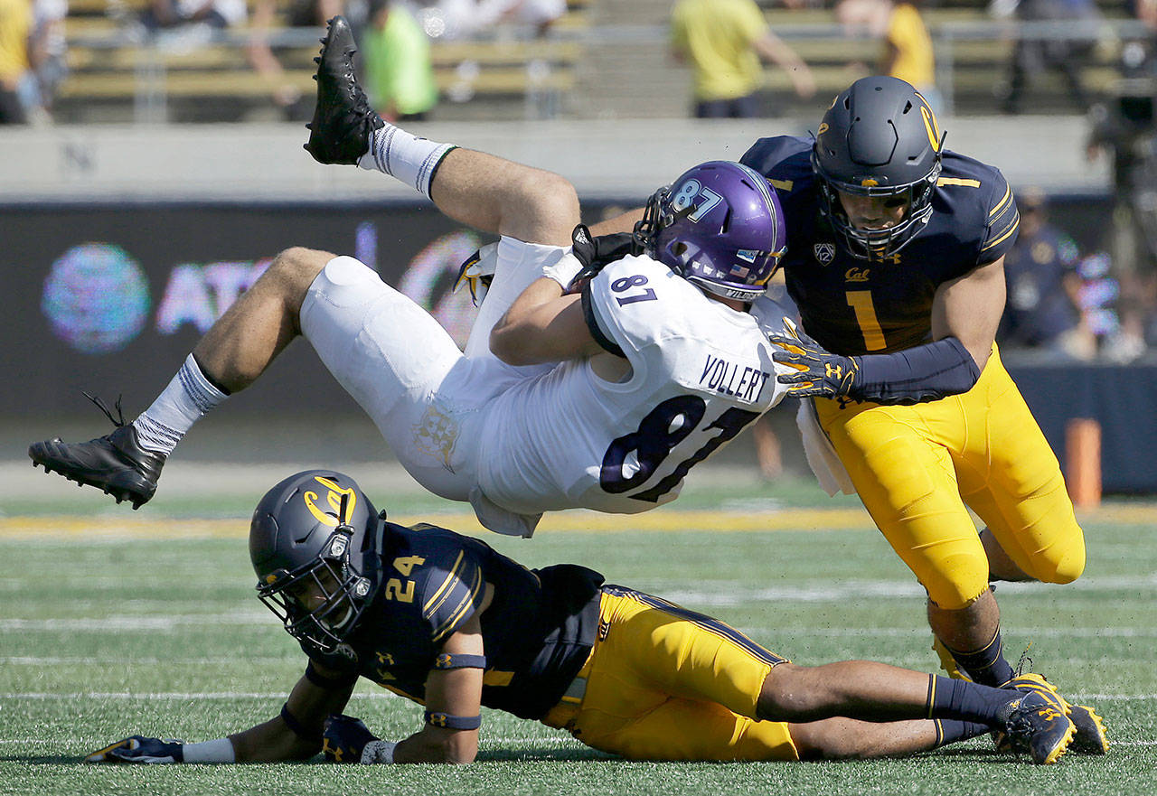 California linebacker Devante Downs (1), a Mountlake Terrace alum, and teammaten Camryn Bynum (24) tackle Weber State tight end Andrew Vollert (87) during a game Sept. 9, 2017, in Berkeley, Calif. (AP Photo/Jeff Chiu)