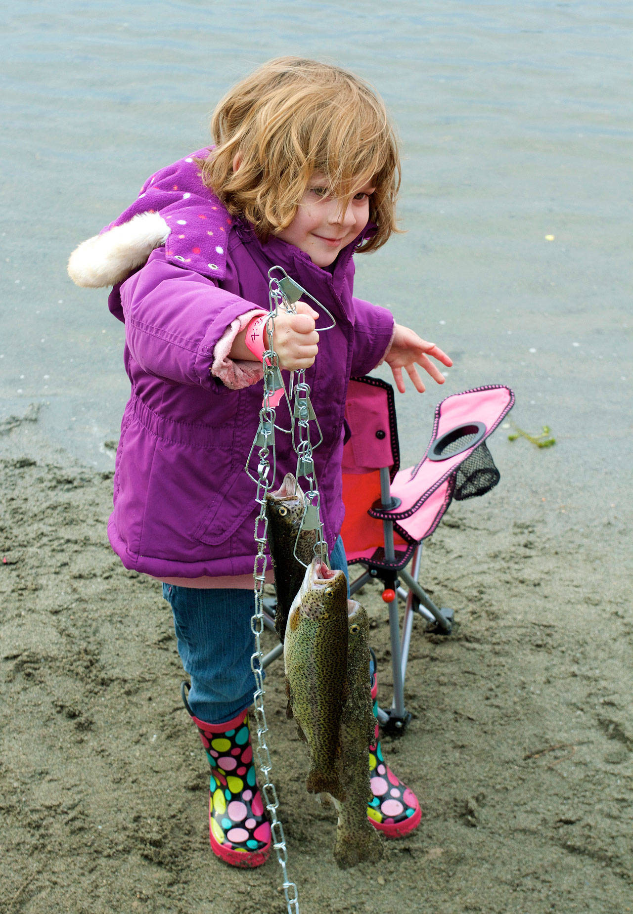 Kahlan Hawley, 4, displays her catch at a fishing event in Everett in 2016. (Photo by Mike Benbow)