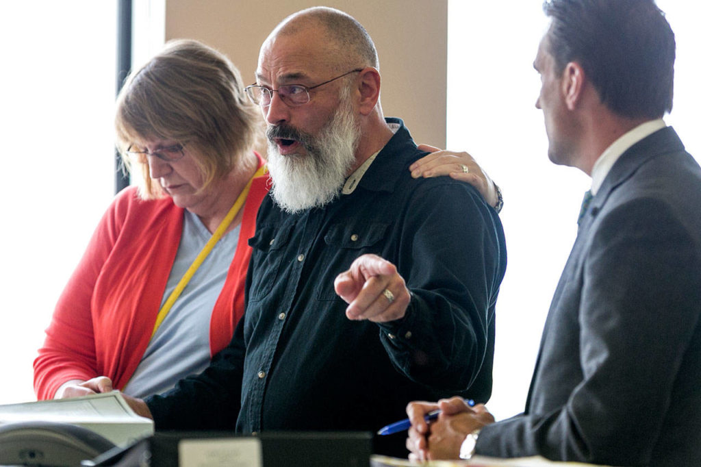 Richard Glover (center), whose mother was killed and whose sister was assaulted, addresses the court during the sentencing of John Kuljis on Friday at the Snohomish County Courthouse in Everett. (Kevin Clark / The Herald)
