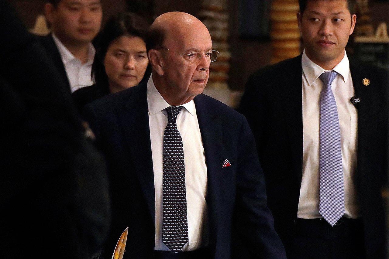 U.S. Commerce Secretary Wilbur Ross (center), arrives at a hotel after meeting with Chinese officials in Beijing on Thursday. (AP Photo/Andy Wong)
