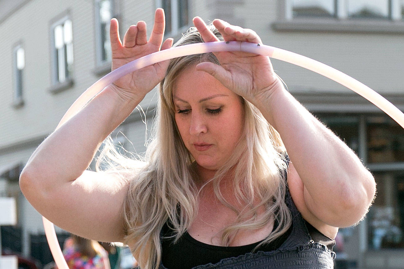 Shannon Dey performs with her handmade hoops on the first day of the Snohomish Farmers’ Market in Snohomish on May 3, 2018. (Kevin Clark / The Herald)