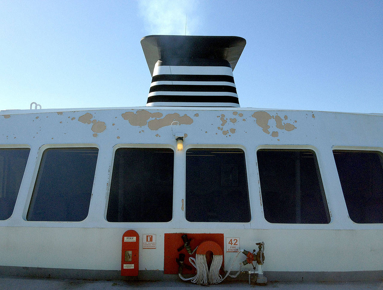 A stack on one of the Jumbo Mark II state ferries emits exhaust during a sailing between Seattle and Bainbridge Island. (Chuck Taylor / The Herald)