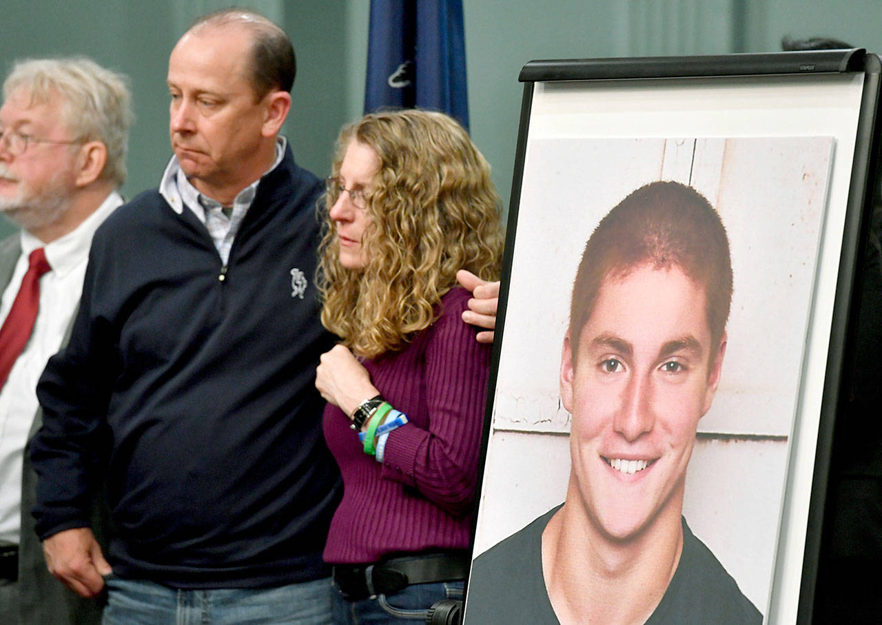 Jim and Evelyn Piazza (center) stand by as Centre County, Pennsylvania, prosecutors discuss the investigation into the death of their son, Timothy Piazza, who is seen in the photo at right, during a news conference last year. (Abby Drey /Centre Daily Times via AP, File)