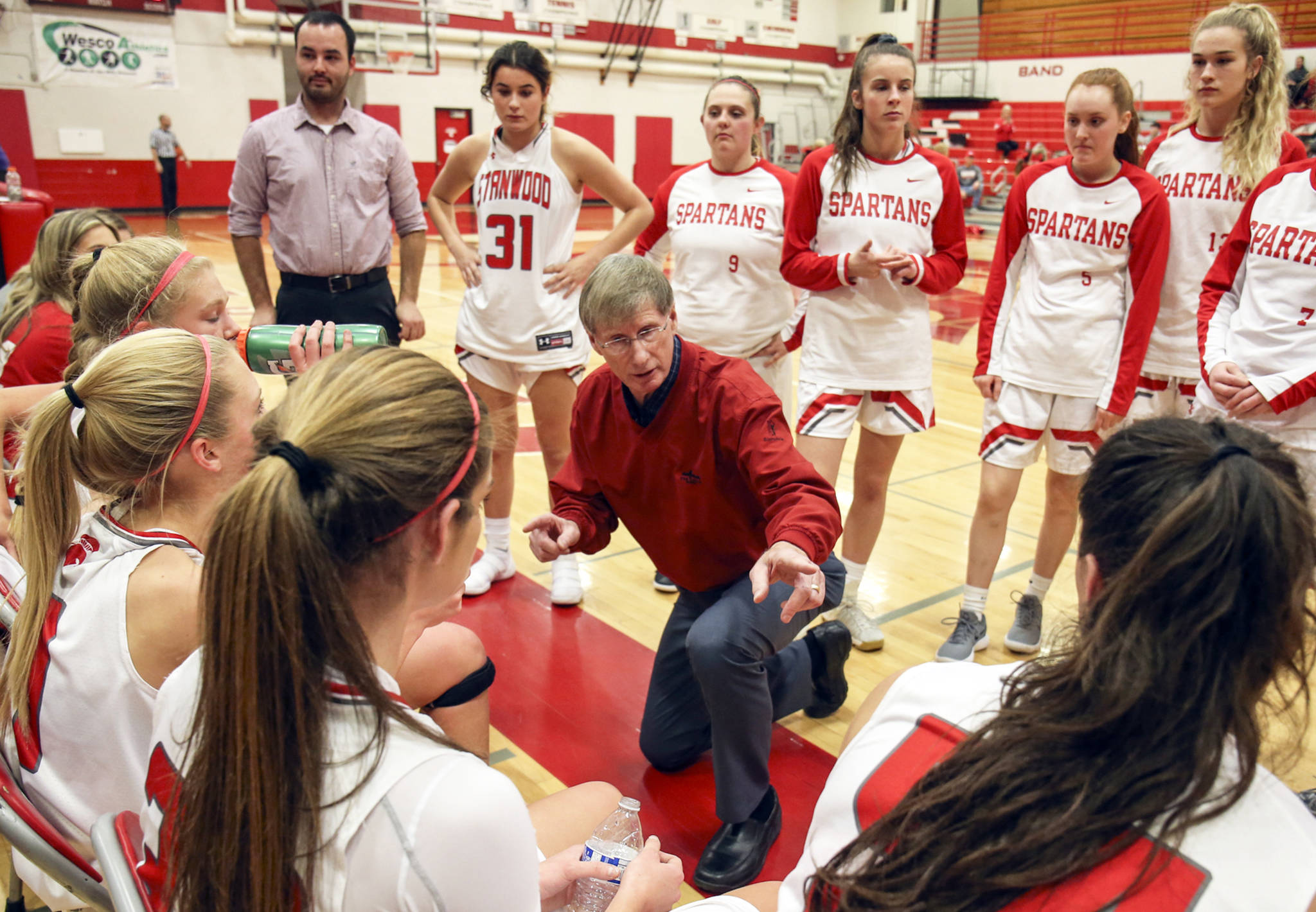 Stanwood High School coach Dennis Kloke addresses his team during a timeout against Everett High School in Stanwood on Dec. 13. (Kevin Clark / The Daily Herald)