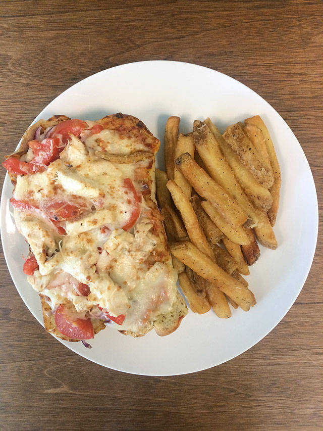 The chicken grinder is served open face with marinara sauce, red onions, tomatoes and mozzarella cheese on focaccia bread. (Evan Thompson / The Herald)