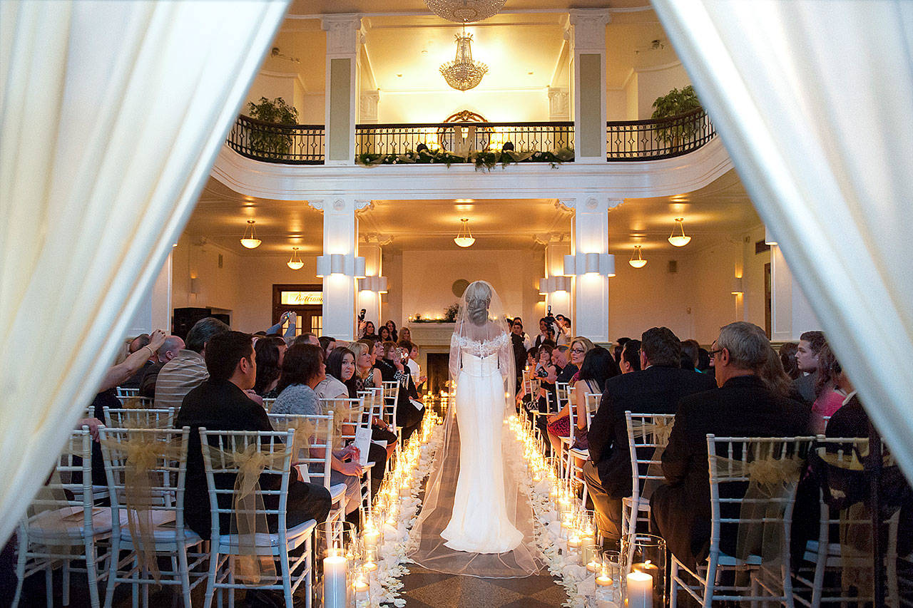 A bride walks down the aisle during her wedding in the Monte Cristo Ballroom in Everett. (Blue Rose Photography LLC)