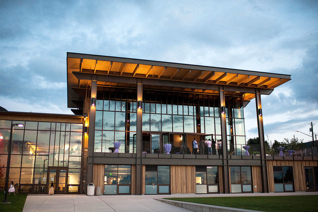 Wedding guests stand around on the balcony at Rosehill Community Center in Mukilteo. (Blue Rose Photography LLC)
