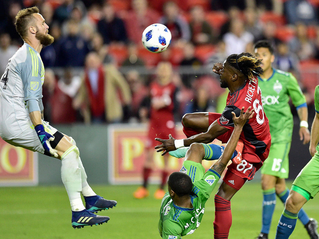 Seattle goalkeeper Stefan Frei leaps to make a save on Toronto’s Tosaint Ricketts during the second half of the Sounders’ 2-1 win Wednesday in Toronto. (Frank Gunn/The Canadian Press via AP)