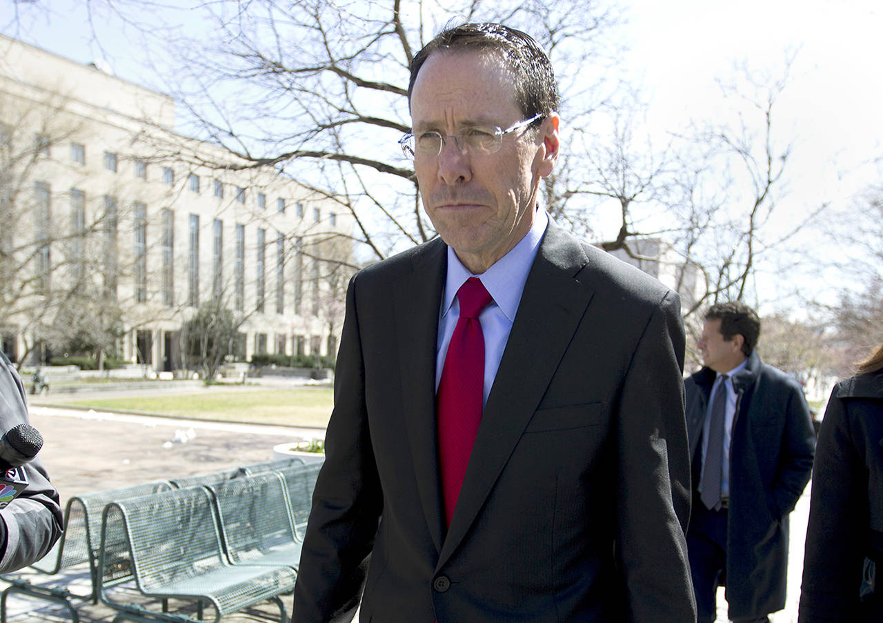 In this March 22 photo, AT&T CEO Randall Stephenson leaves the federal courthouse in Washington. (AP Photo/Jose Luis Magana)