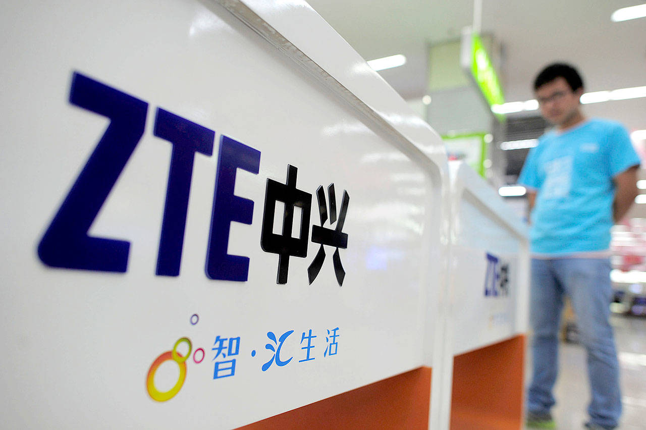 A salesperson sells mobile phones produced by ZTE Corp. at an appliance store in Wuhan in central China’s Hubei province. (Chinatopix Via AP, File)