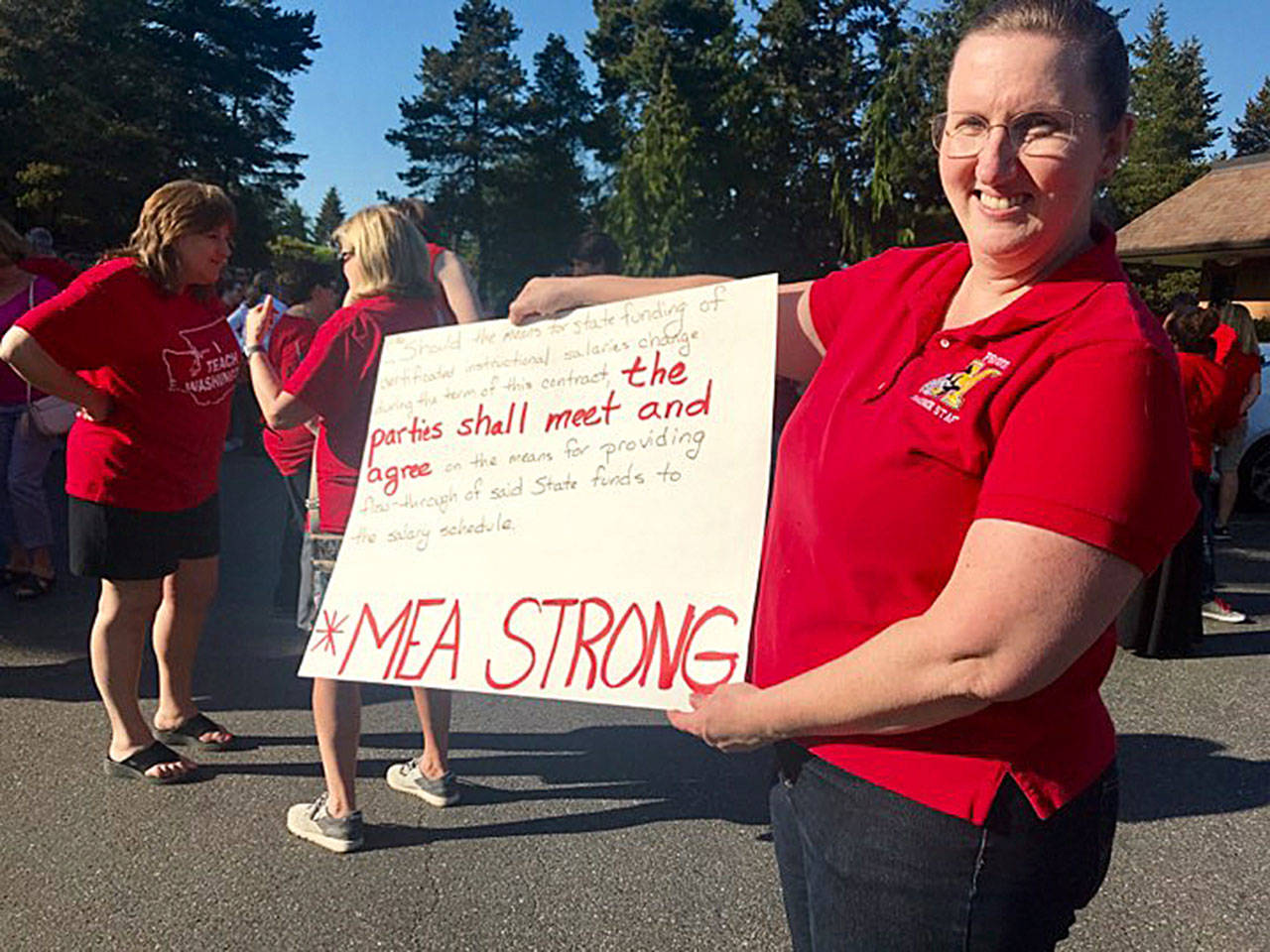 About 150 teachers and other staff packed the meeting of the Mukilteo School Board on Monday to demand renegotiation of their contract. (Andrea Brown / The Herald)
