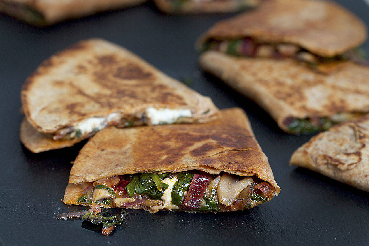 Mushroom, spinach and goat cheese quesadillas make for a fast-cooked meal that begs to be devoured immediately. (Photo by Deb Lindsey for The Washington Post)