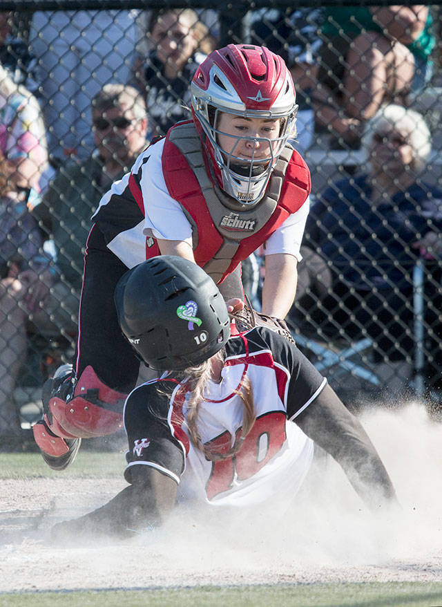 Snohomish’s Joy Winston(10) slides safely under the tag of Marysville Pilchuck catcher Sydney Zachry during the Panthers’ 8-6 win over the Tomahawks in a 3A District 1 semifinal Tuesday at Phil Johnson Fields in Everett. (Andy Bronson / The Herald)