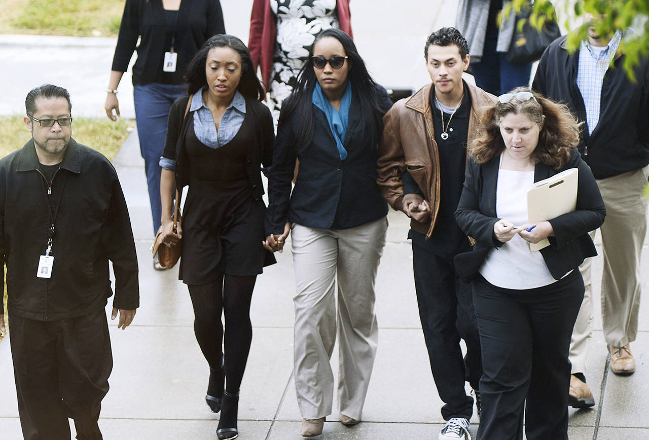 Ina Rogers (center) walks to Solano County Superior Court in Fairfield, California, on Wednesday to face multiple charges of felony child abuse. Bail for a California mother of 10 children who officials say suffered long-term abuse was set at nearly $500,000 after the judge said she remains a danger to the kids. (Robinson Kuntz/Daily Republic via AP)