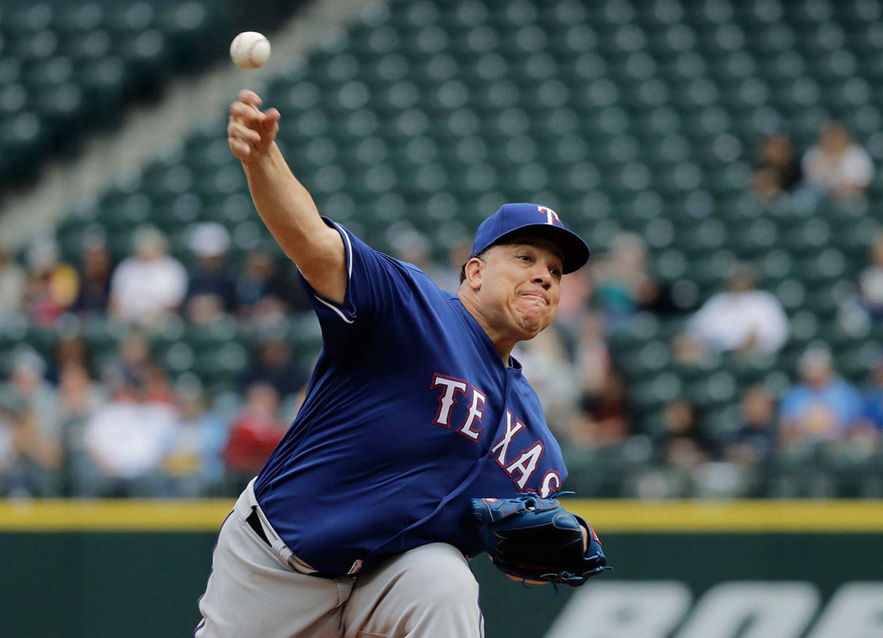 Texas Rangers starting pitcher Bartolo Colon throws against the Seattle Mariners during Monday’s game at Safeco Field. (AP Photo/Ted S. Warren)
