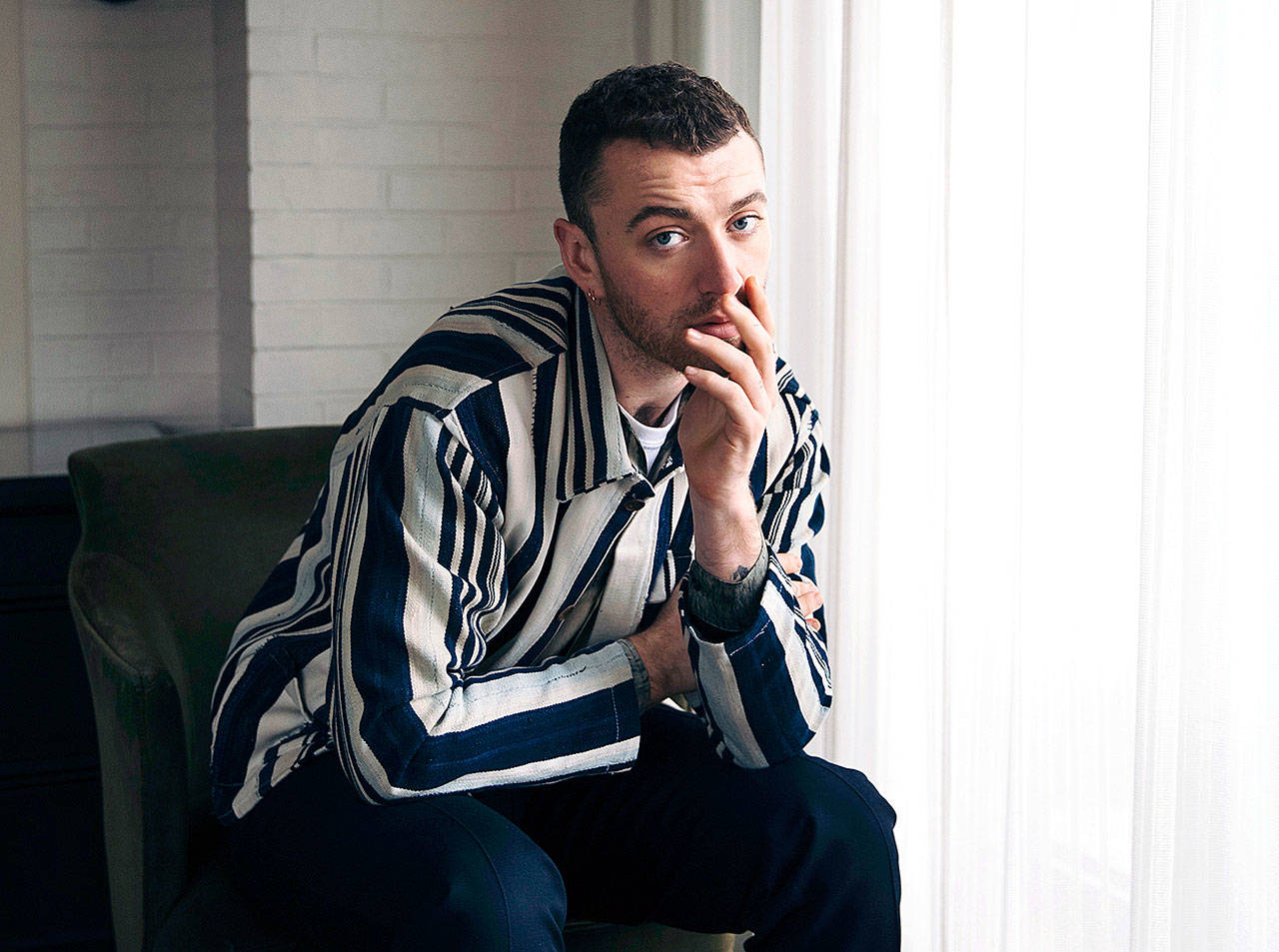 A study of hundreds of thousands of popular songs over the last three decades has found a downward sonic trend in happiness and an increase in sadness. Some songs with a low happiness index in 2014 include “Stay With Me” by Sam Smith. (Photo by Victoria Will/Invision/AP File)