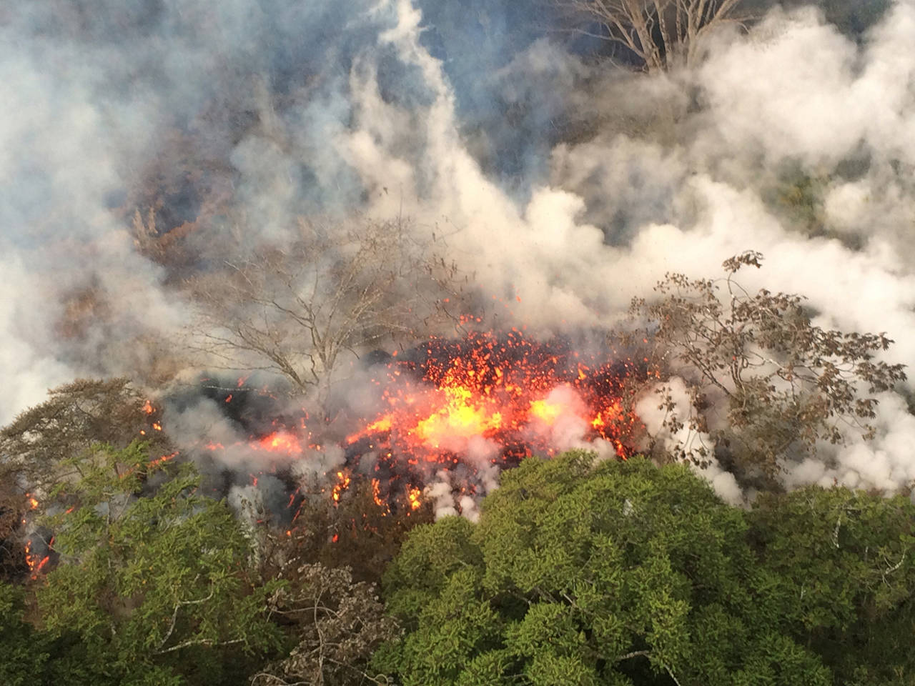 Lava spatters from an area between active Fissures 16 and 20 photographed at 8:20 a.m. on May 16. (U.S. Geological Survey via AP)