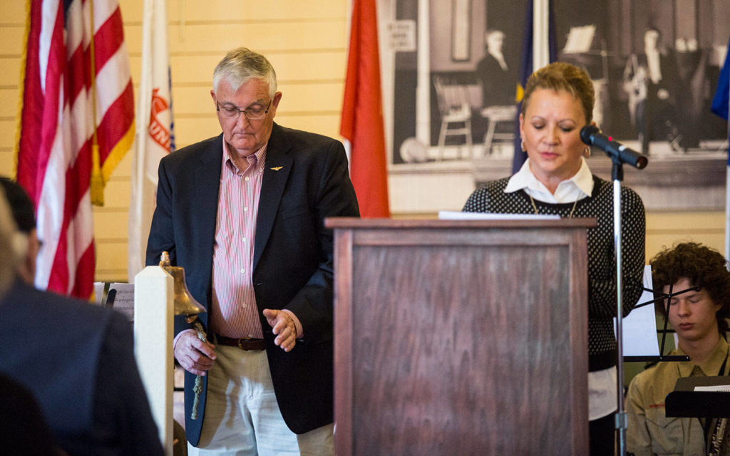 Jim Joyce rings a bell for ever name said by Lynda Behring at the Memorial Day dedication of the Stanwood Area Historical Society Community Veterans Memorial at the Floyd Norgaard Cultural Center on Monday, May 28, 2018. (Andy Bronson / The Herald)
