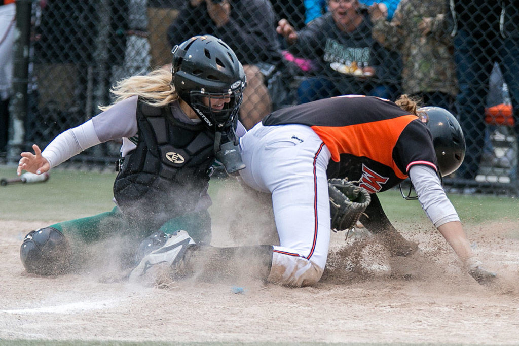 Jackson’s Sam Mutolo (left) tags out Monroe’s Hannah Akin during the 4A district championshipon May 17, 2018, in Everett. Jackson won 2-0. (Kevin Clark / The Herald)
