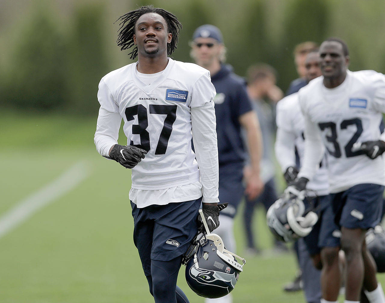 Seattle Seahawks rookie cornerback Tre Flowers (37) runs in from the field, Friday, May 4, after NFL rookie camp in Renton, Wash. The Seahawks announced Flowers signed his rookie contract Thursday. (Ted S. Warren / Associated Press)