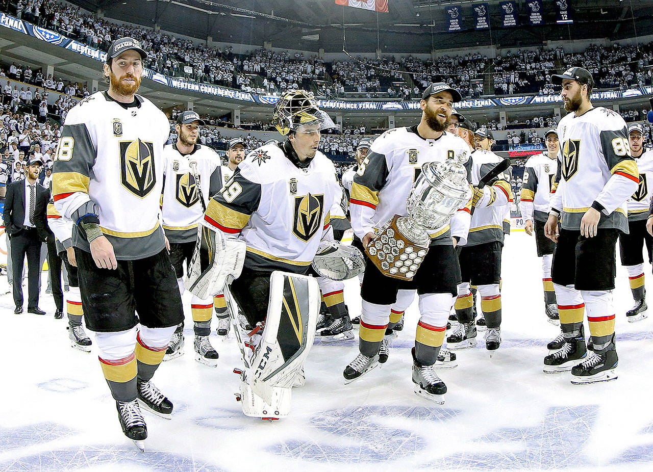 Vegas Golden Knights’ James Neal (18), Deryk Engelland (5), goaltender Marc-Andre Fleury (29) and the rest of the team celebrate after defeating the Winnipeg Jets during NHL Western Conference Finals game 5 in Winnipeg on Sunday. (Trevor Hagan/The Canadian Press via AP)