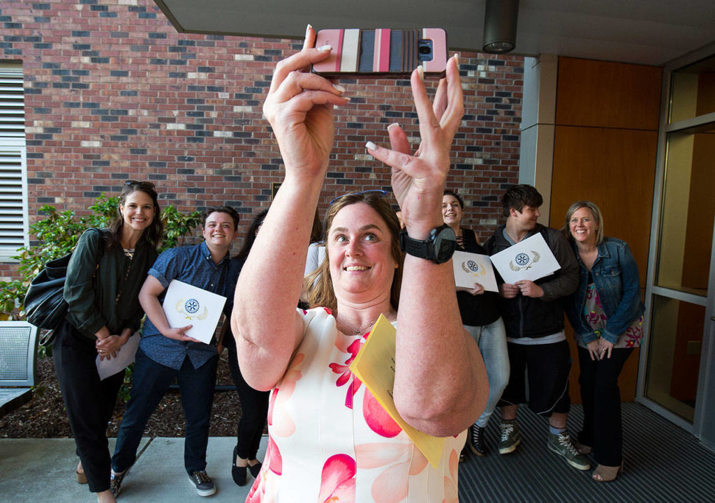 Sequoia High Principal Kelly Shepherd takes a group photo with her school’s scholarship winners, and staff, after the Rotary Club of Everett handed out $202,200 worth of scholarships to 56 students at the Everett Public Schools Community Resource Center on Monday in Everett. (Andy Bronson / The Herald)

