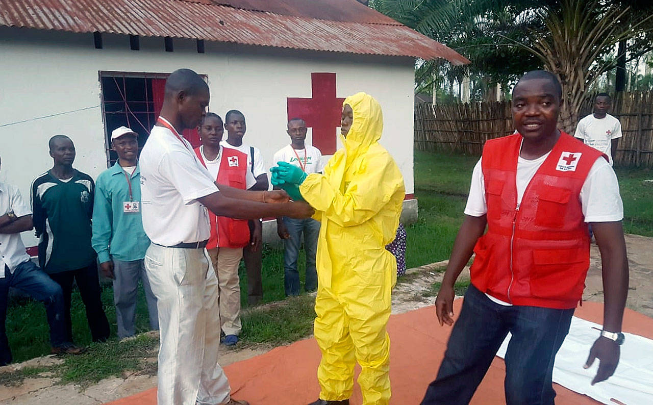 Members of a Red Cross team don protective clothing before heading out to look for suspected victims of Ebola in Mbandaka, Congo, on May 14. (Karsten Voigt/International Federation of Red Cross and Red Crescent Societies)