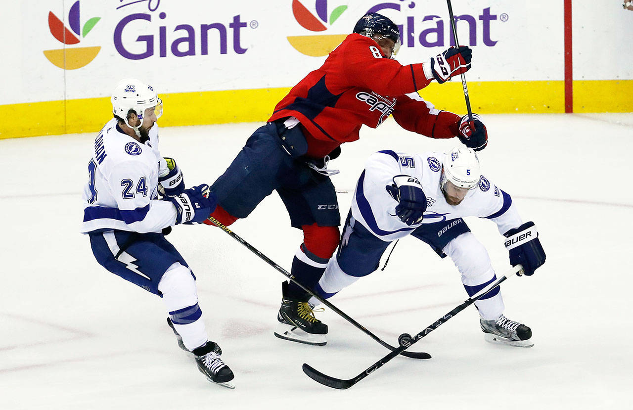 Washington Capitals left wing Alex Ovechkin (8), from Russia, hits Tampa Bay Lightning defenseman Dan Girardi (5) with Lightning right wing Ryan Callahan (24) nearby during the first period of Game 6 of the NHL Eastern Conference finals hockey playoff series Monday, May 21, 2018, in Washington. (AP Photo/Alex Brandon)