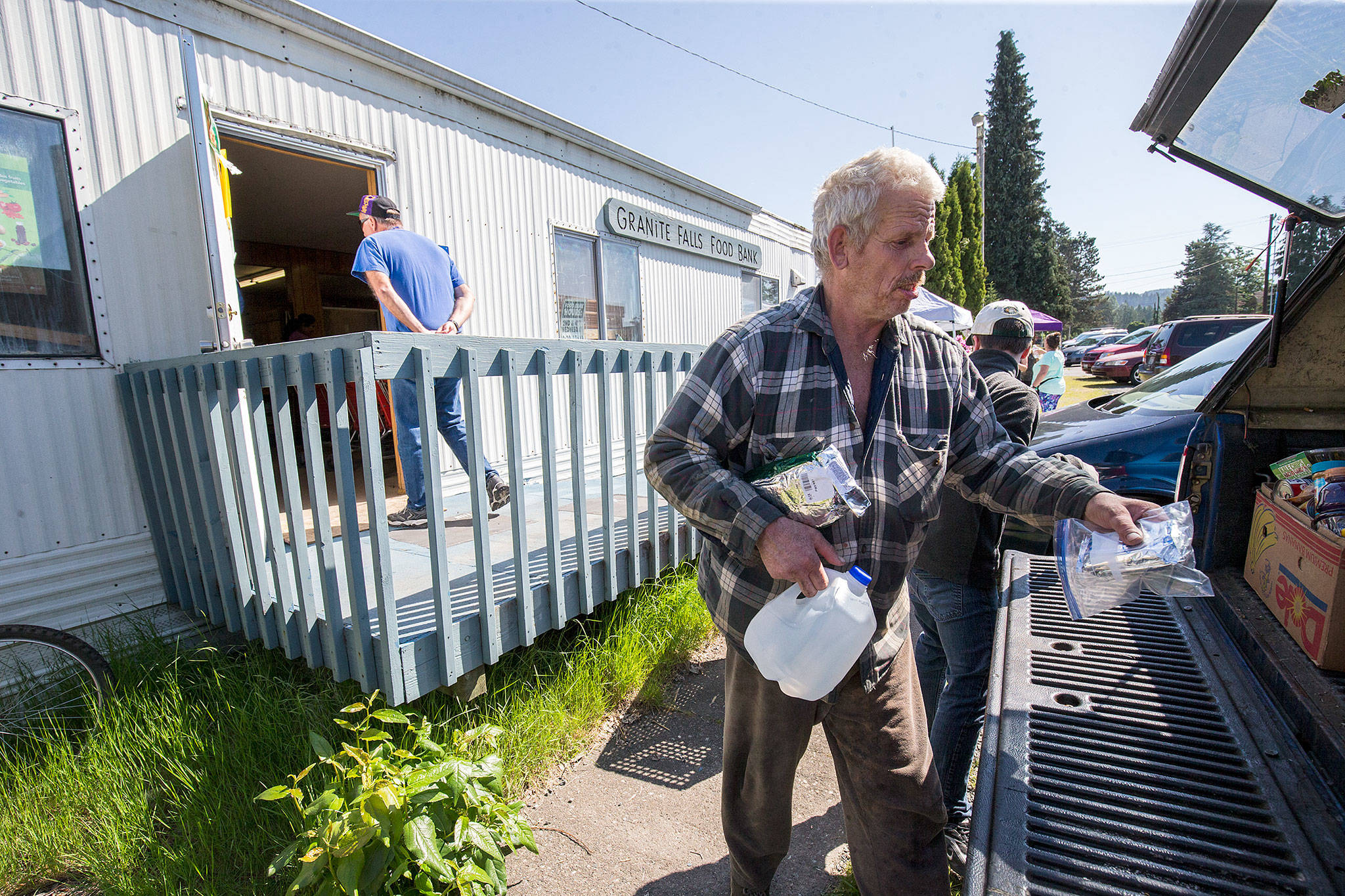 Carey Deeter puts groceries in his truck after leaving the Granite Falls Food Bank, a white metal-sided trailer on the corner of S. Granite and Union Street, on its final food distribution day on Wednesday in Granite Falls. The food bank will be moving from the site that has housed the service for 40 years. (Andy Bronson / The Herald)