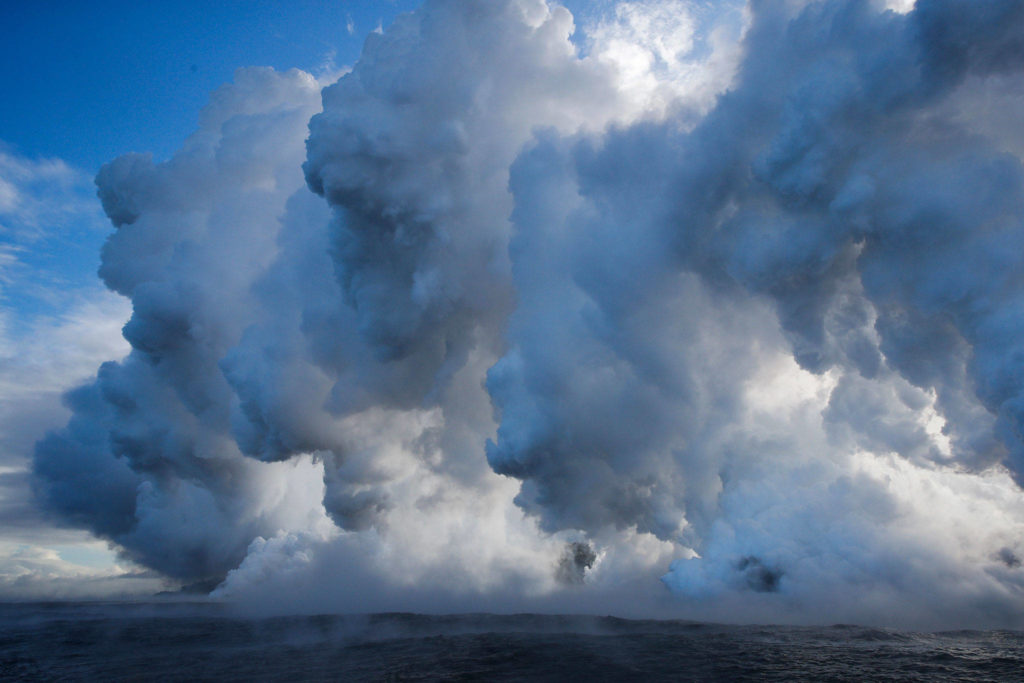 Plumes of steam rise as lava enters the ocean near Pahoa, Hawaii on May 20. (AP Photo/Jae C. Hong)
