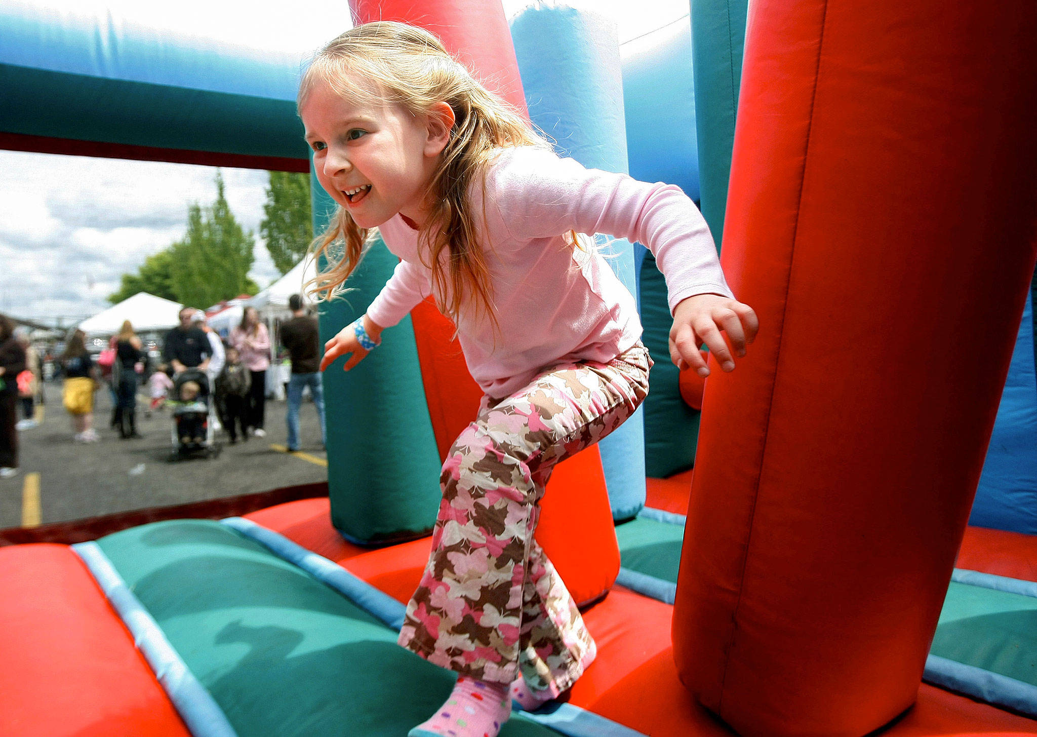 Sophie Warren of Edmonds, barges through the columns of an inflatable obstacle course during a previous Edmonds Rotary Waterfront Festival. The 2018 event is June 1-3 at the Port of Edmonds Marina. (Herald file)