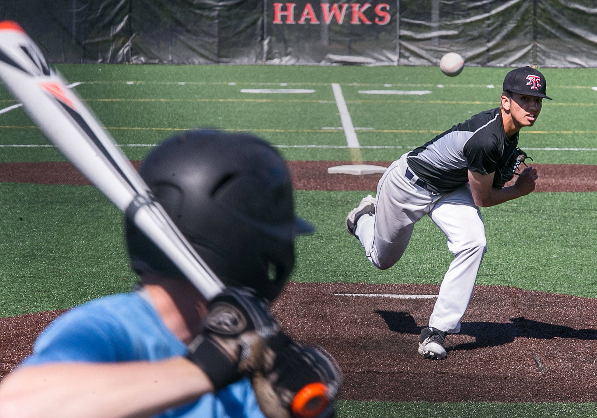 Kasey Boe throws a pitch to Andrew Younglove Wednesday during the Mountlake Terrace baseball team’s practice session at Mountlake Terrace High School. (Kevin Clark / The Herald)