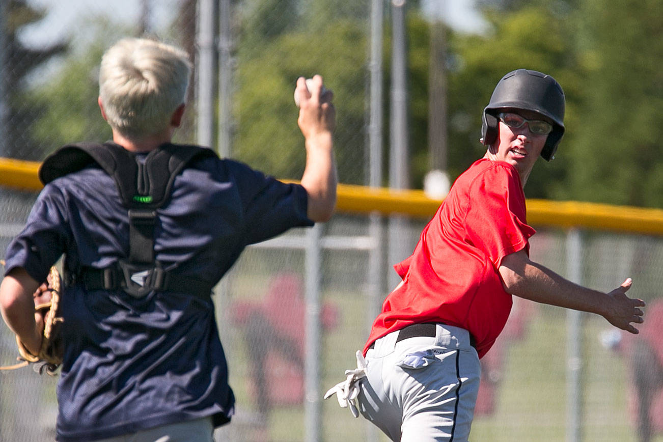 Layne Zuschin catches down Bret Serres in a pickle execise Wednesday afternoon during practice at Mountlake Terrace High School in Mountlake Terrace on May 23, 2018. The Hawks are headed to state for the first time in school history. (Kevin Clark / The Herald)