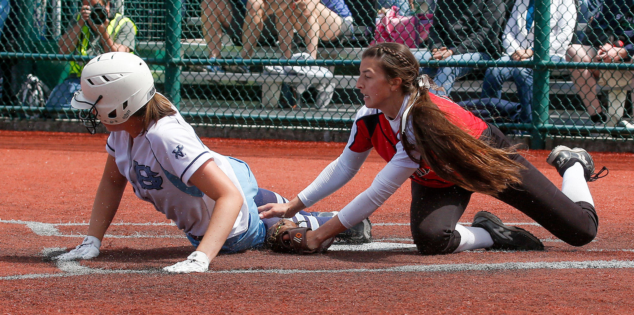 Snohomish pitcher Bailey Greenlee tries to tag Gig Harbor’s Kaylee Costello at home during a 3A state tournament game on May 25, 2018, at the Regional Athletic Complex in Lacey. Snohomish won 5-3 and later beat Kelso 5-0 to advance to the state semifinals. (Andy Bronson / The Herald)