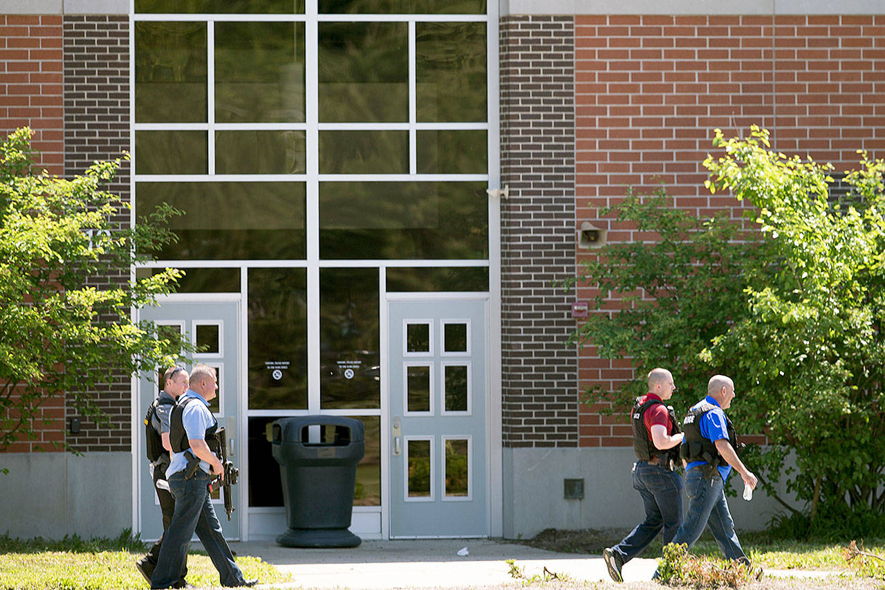 Law enforcement officers walk outside Noblesville West Middle School in Noblesville, Indiana, after a shooting on Friday. (Robert Scheer/The Indianapolis Star via AP)