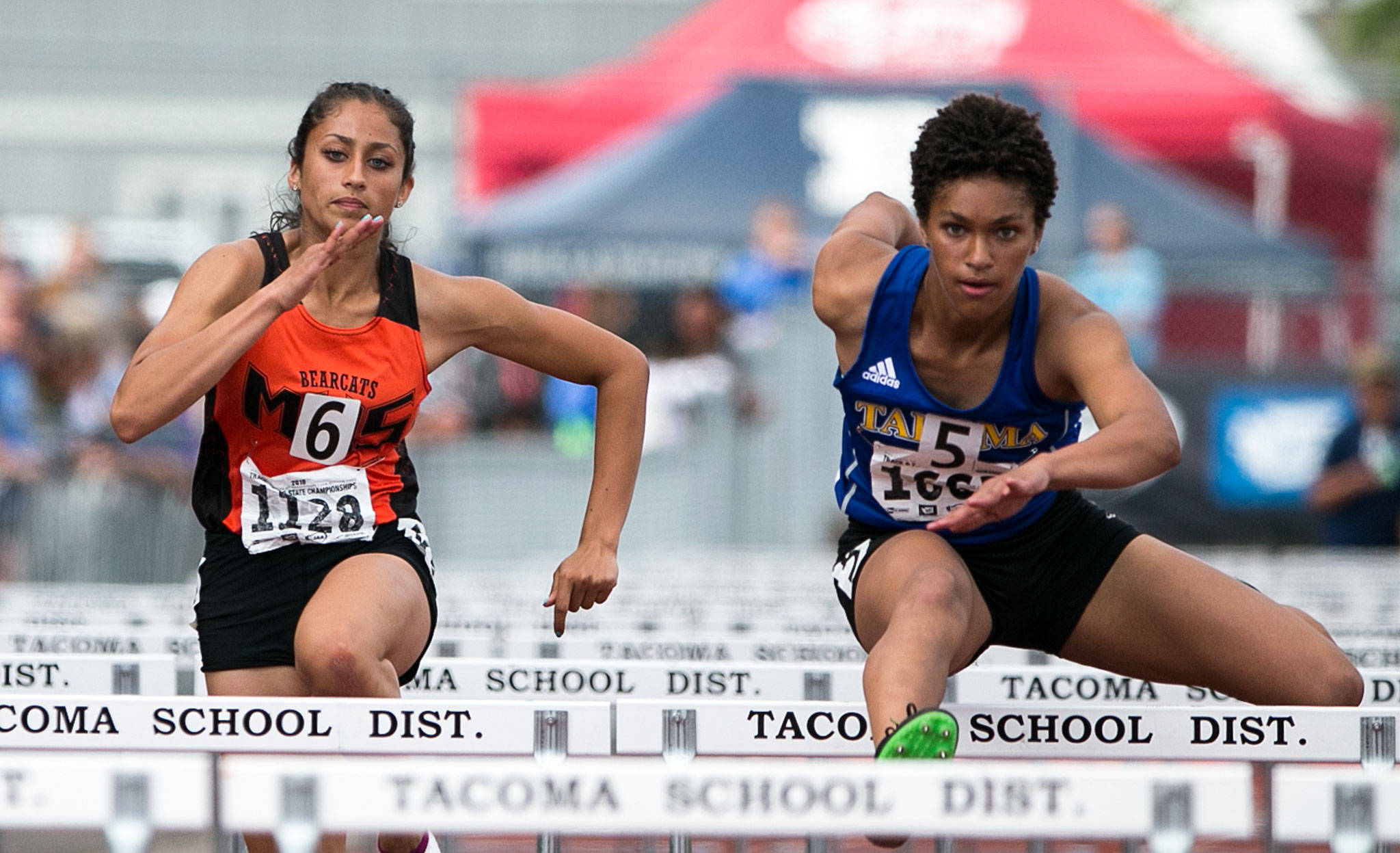 Monroe’s Hannah Ganashamoorthy (left) races Tahoma’s Alaina Brady in the 4A 100-meter hurdles during the state track and field championships on May 25, 2018, at Mount Tahoma High School in Tacoma. (Kevin Clark / The Herald)