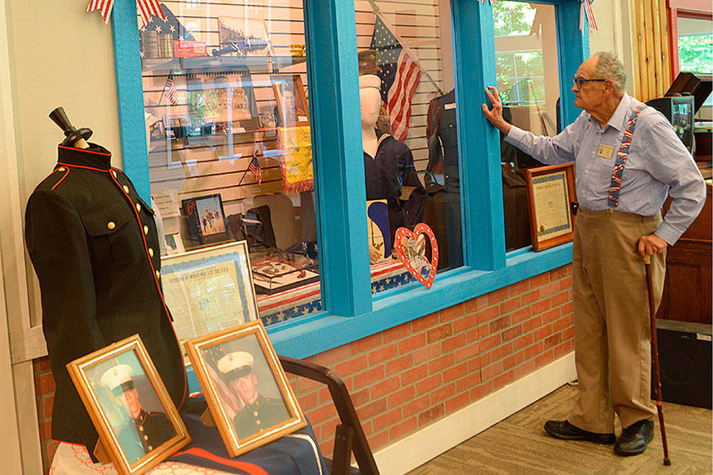 Ken Cage, president of the Marysville Historical Society, checks out the new military display at the museum near Jennings Memorial Park. (Steven Powell/Marysville Globe)
