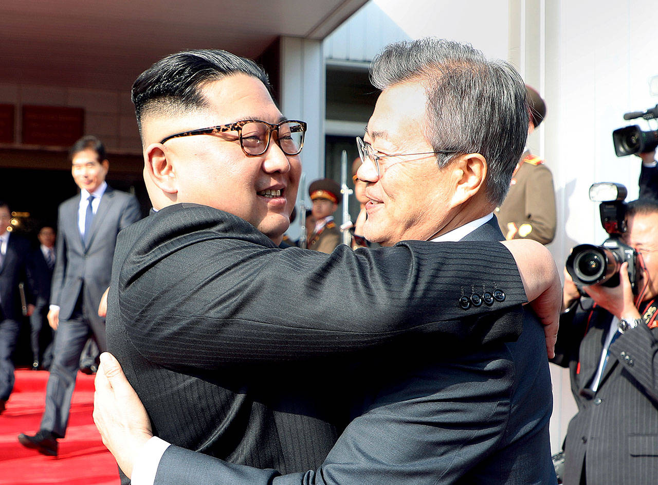 North Korean leader Kim Jong Un (left) and South Korean President Moon Jae-in embrace after their meeting at the northern side of the Panmunjom in North Korea on Saturday. (South Korea Presidential Blue House/Yonhap via AP)