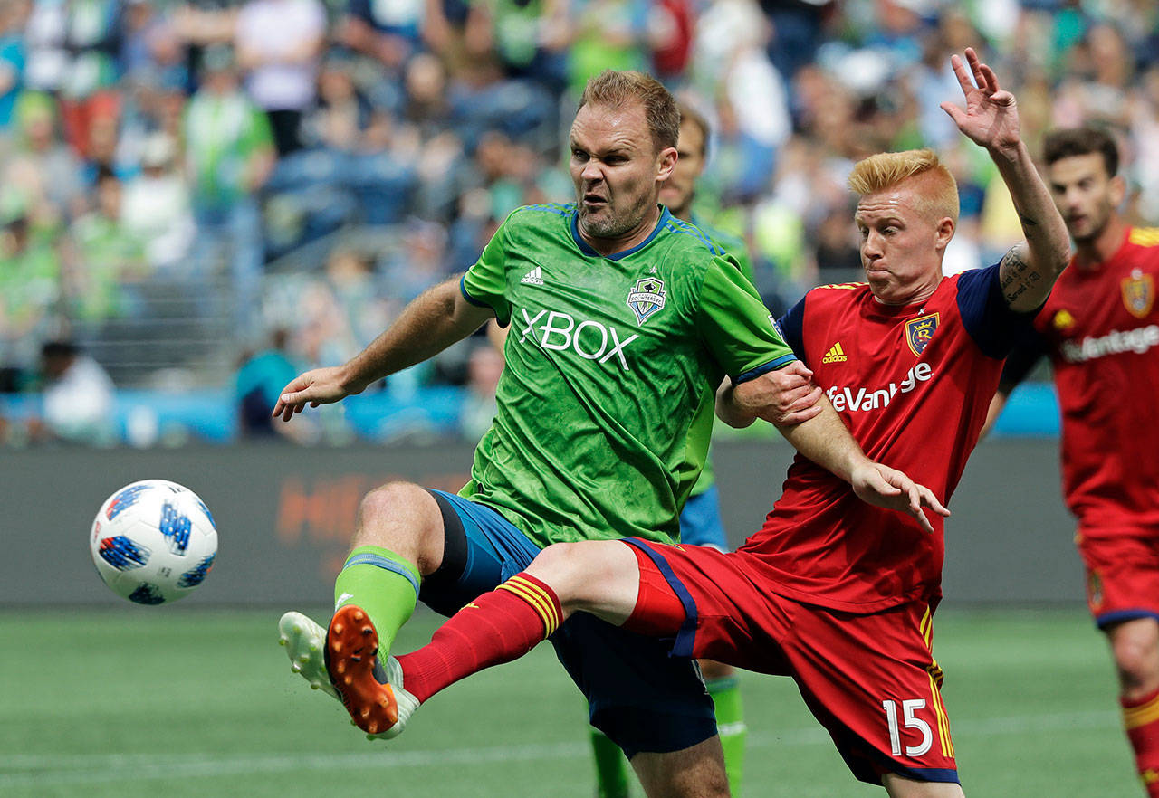 Sounders defender Chad Marshall (left) battles with Real Salt Lake defender Justen Glad (15) for the ball during the second half of a match on May 26, 2018, in Seattle. Real Salt Lake won 1-0. (AP Photo/Ted S. Warren)