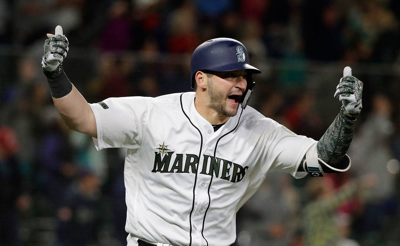 Seattle’s Zunino celebrates after hitting a walk-off home run during the 12th inning of Saturday’s game at Safeco Field. (AP Photo/Ted S. Warren)