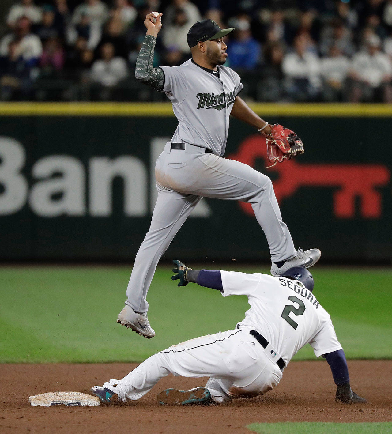 The Mariners’ Jean Segura (2) collides with Twins shortstop Gregorio Petit after being forced at second during the eighth inning of a game May 26, 2018, in Seattle. (AP Photo/Ted S. Warren)