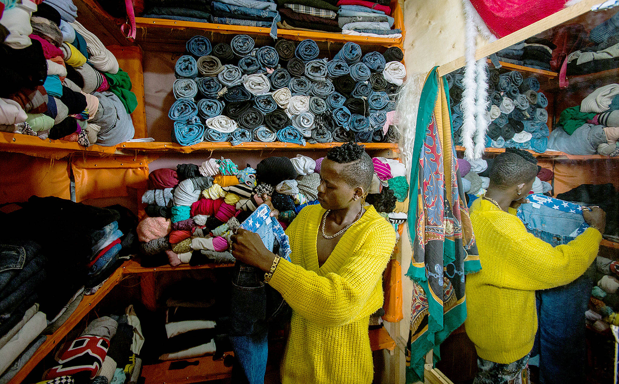 Owners of small shops at Nyamirambo market in Kigali, Rwanda, display used clothing imported from around the world. A shirt can go for less than a dollar. (Jacques Nkinzingabo for The Washington Post)