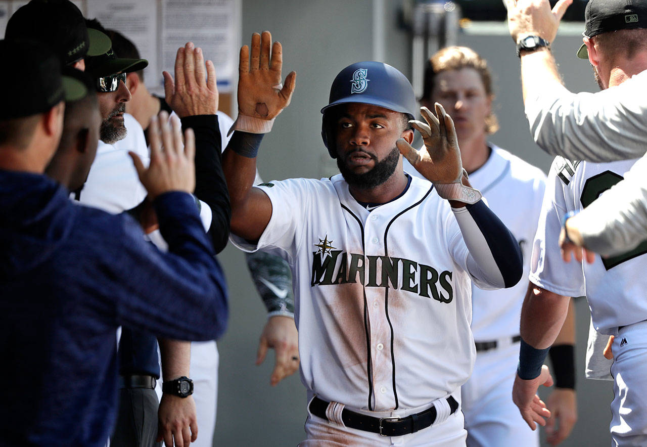 Seattle’s Denard Span is congratulated after scoring a run in the sixth inning of Monday’s game at Safeco Field. (AP Photo/Elaine Thompson)