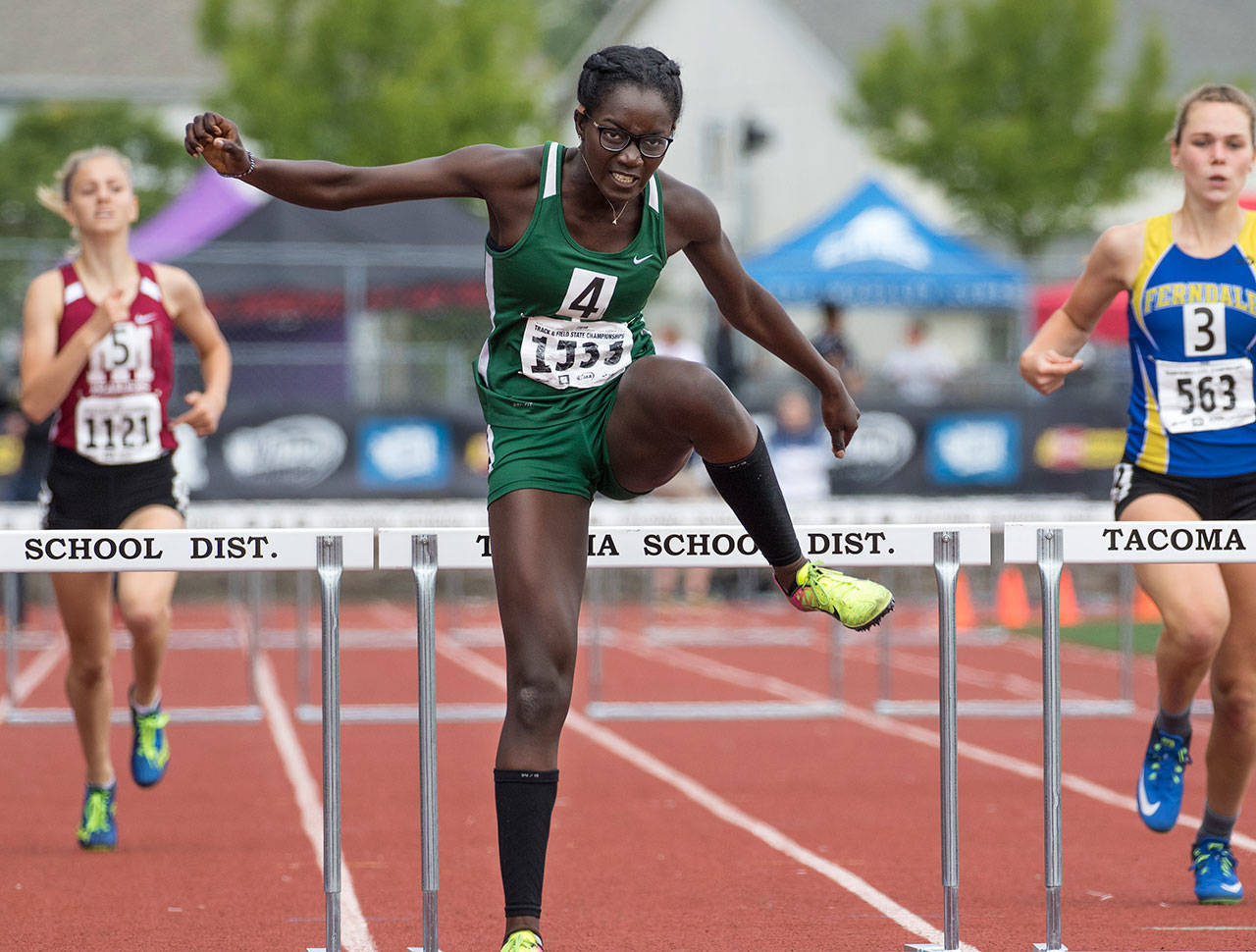 Shorecrest’s Ami Njadoe, middle, clears the last hurdle and heads to the finish line to win the 3A Girls 300 Meter Hurdles event on Saturday during the Washington State Track and Field Championships in Tacoma. (Photo by Patrick Hagerty)