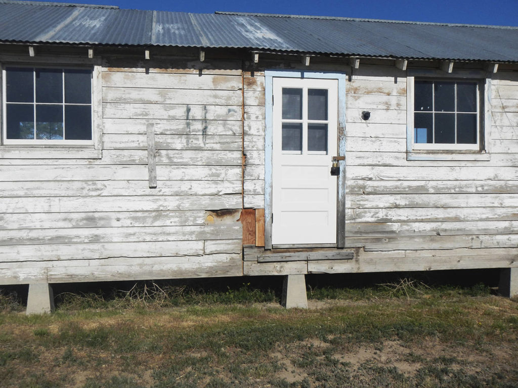 This shows the exterior of a building at Minidoka National Historic Site where thousands of people of Japanese ancestry were in custody of the War Relocation Authority during World War II in southern Idaho. After the war, many of the 600 buildings were allocated to veterans and the land was homesteaded. What remained was salvaged by locals for their farmhouses and barns. (Glen Watanabe)
