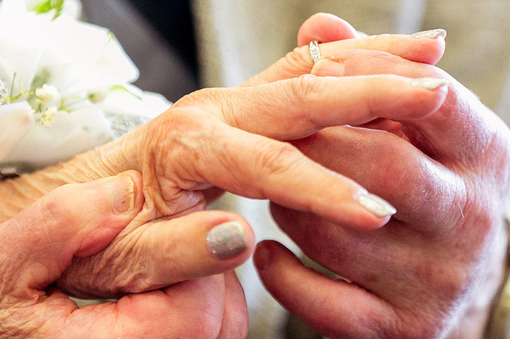 Kal Leichtman places a ring on Marilyn Ogden’s finger during their wedding ceremony Wednesday at the Snohomish County Courthouse in Everett. (Kevin Clark / The Herald)
